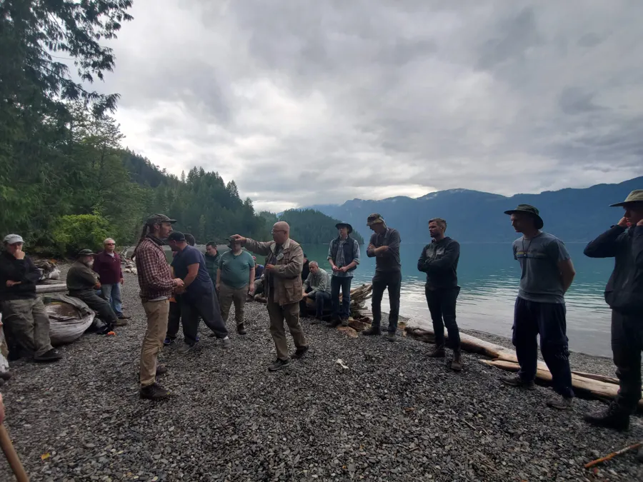 men in a line at the lakeshore, 2019