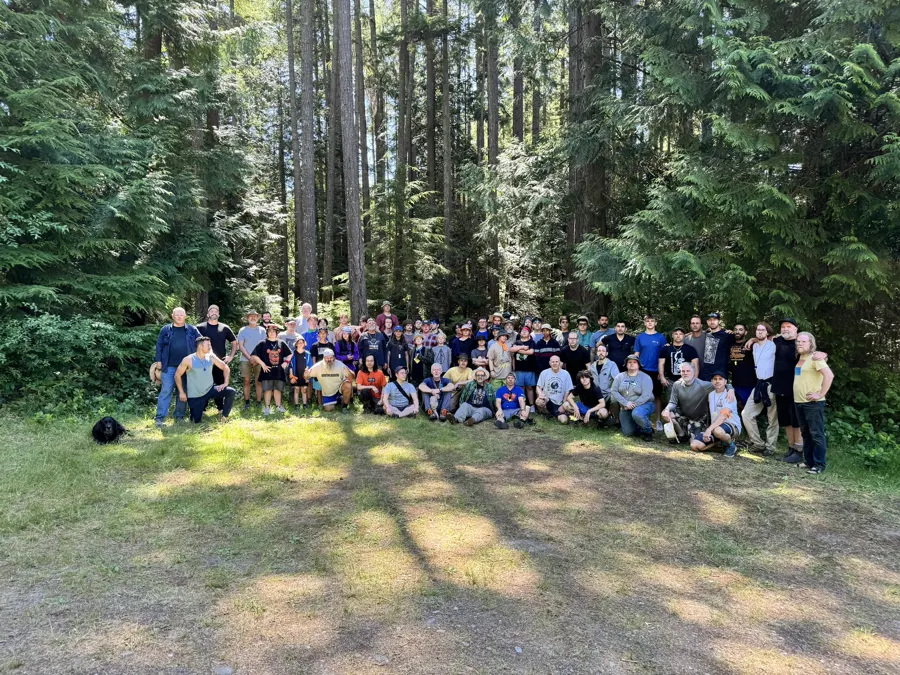 whole weekend group photo under the trees, 2024