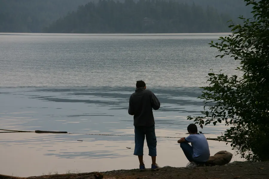 man and young man looking out at the lake